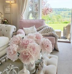 a living room filled with furniture and flowers