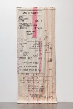 an old movie ticket sitting on top of a wooden table next to a white wall