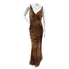 Leopard maxi dress by Dolce & Gabbana Spring 2020 Ready-to-Wear Made in Italy Brown semi-sheer leopard print throughout Layered effect with black slip dress lining Drape waist detail Back zipper closure Subtle ruffles at bottom hem 100% silk (lining: 78% acetate, 16% nylon, 6% spandex) Excellent condition, zero visible wear. Size/Measurements: (approximate, taken flat) Size 44 IT 34" Bust 29" Waist 39" Hips 44" Length (waist to bottom hem) Chic Leopard Print Evening Maxi Dress, Chic Leopard Print Maxi Dress For Evening, Sleeveless Leopard Print Evening Dress, Elegant Leopard Print Maxi Dress For Evening, Elegant Leopard Print Dress For Party, Elegant Leopard Print Formal Dress, Fitted Leopard Print Dress For Formal Occasions, Formal Fitted Leopard Print Dress, Elegant Leopard Print Party Dress