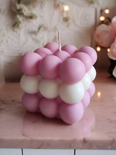 a pink candle sitting on top of a counter