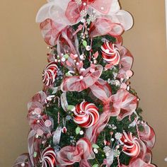 a christmas tree decorated with candy canes and bows