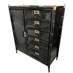 a black cabinet with gold handles and drawers