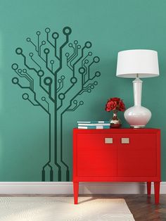 a red cabinet sitting next to a lamp on top of a table