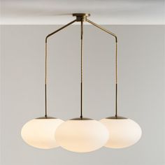 three light fixtures hanging from a ceiling fixture