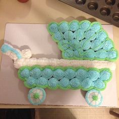 a cake shaped like a baby's carriage on top of a piece of paper