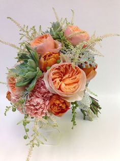 an arrangement of flowers in a vase on a table