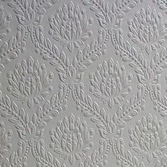 the textured wallpaper is white and has an intricate design on it's surface