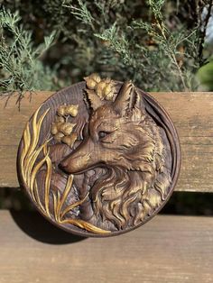 a wooden carving of a wolf with flowers on it's head is sitting on a bench