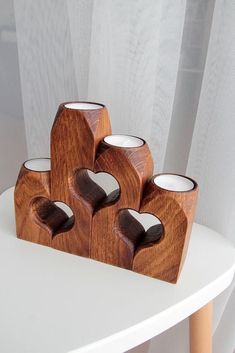 four wooden candles are on a white table