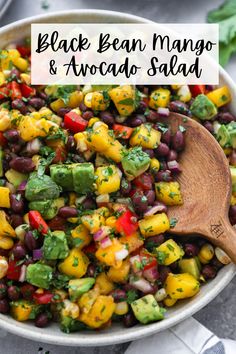 a bowl filled with black beans, avocado and cilantroo salsa