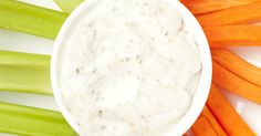 carrots, celery and celery sticks with ranch dip in a white bowl