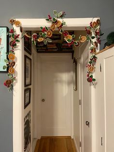 the hallway is decorated with red and green decorations, along with pictures on the wall