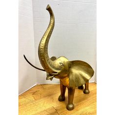 an elephant statue sitting on top of a wooden floor