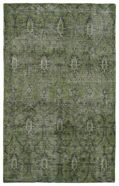 a green rug with an intricate design on it