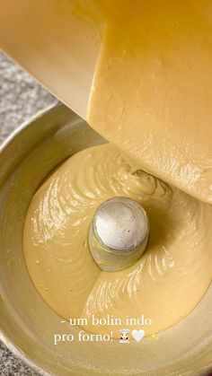 a food processor filled with yellow liquid on top of a counter