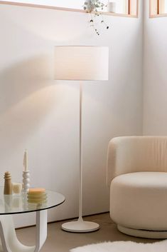 a living room with a white chair and table