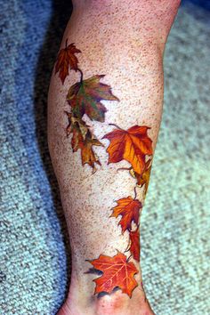 a person's leg with leaves on it