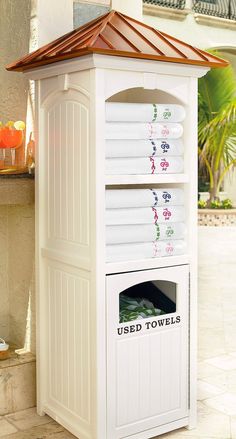 a white outdoor storage unit with towels on it's top and the words used towels written in english