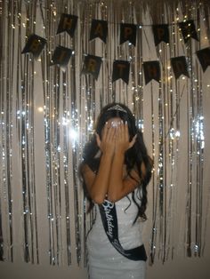 a young woman covering her face in front of a curtain with the word fab on it