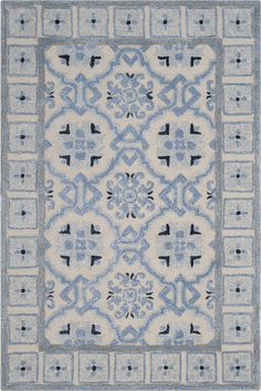 a blue and white rug with an intricate design