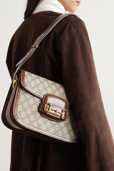 Gucci only revived its '1955' style a few seasons ago, but it's already set to be the next It bag - both Sienna Miller and Adwoa Aboah have been spotted carrying it. Made in Italy from the house's signature monogrammed coated-canvas, it has a saddle silhouette and is trimmed with tan leather. Match your jewelry to the equestrian-inspired horsebit hardware. Best Designer Bags, It Bag, Gucci Horsebit, Sienna Miller, Bags Aesthetic, Samar, Print Coat, Designer Shoulder Bags, Canvas Shoulder Bag