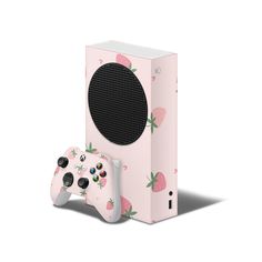 a nintendo wii game controller next to a pink box with strawberries on it,