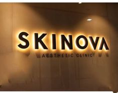 the sign for skinova aesthetic clinic is lit up