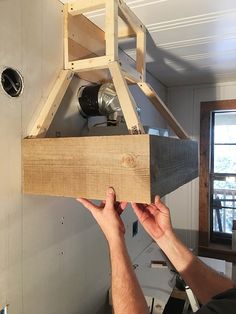 a man is working on an object in the room that looks like it has been made out of wood