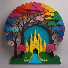 a paper cut out of a castle with trees