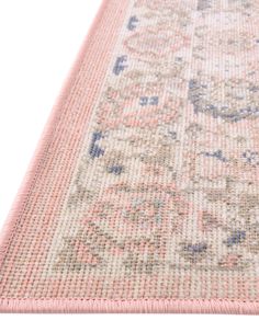 a pink rug with an intricate design on the top and bottom side, in front of a white background