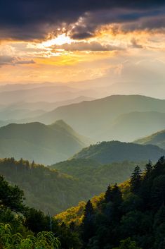 the sun shines brightly through the clouds over mountains in the smoky blue ridge range