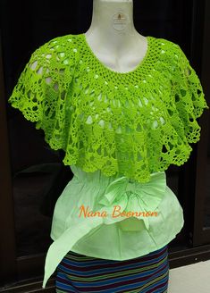 a mannequin wearing a green crochet top