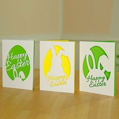 three greeting cards with the words happy easter written in green, yellow and white on them