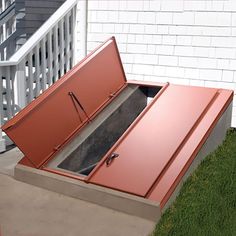 an open metal box sitting on the side of a house