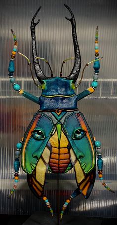 a colorful insect is sitting on a table