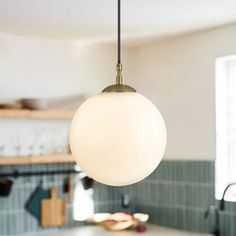 a light hanging from the ceiling in a kitchen