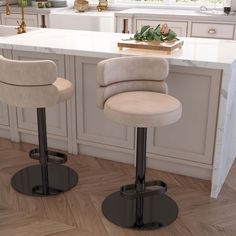 two beige stools sitting in front of a kitchen counter