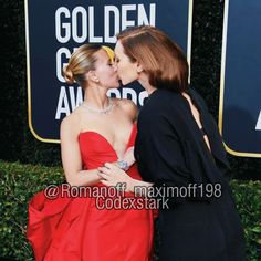 two women kissing each other on the red carpet at an awards event in los angeles