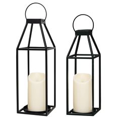 two black metal lanterns with white candles