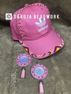 the adidas hat and earring set is pink with multicolored beading