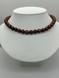 Brown Freshwater Pearl Necklace.  This hand knotted strand features 39 Genuine Brown Freshwater Pearls AA+ High Luster Round to Near Round 10.5-11.2mm Deep Henna color.  I hand knotted these pearls with brown silk thread and finished them with a 925 Silver Fold Over magnetic clasp.  The necklace measures 18 1/2 inches in length.  The Pearls are Genuine and color enhanced.  There are a few surface blemishes.  The necklace pictured is the one you will receive.   Please visit our shop for more pear Brown Pearl Necklace, Henna Color, Chocolate Pearls, Turquoise Stud Earrings, Corpus Christi Tx, Freshwater Pearl Bracelet, Brown Silk, Freshwater Pearls Earrings, Freshwater Pearl Necklace