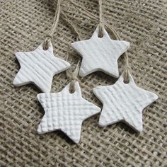 three white ceramic stars hanging from twine