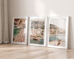 three framed photographs sitting on top of a wooden floor