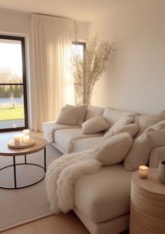 a living room filled with furniture next to a large open window and a white couch