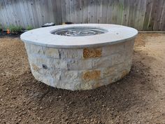 an outdoor fire pit surrounded by dirt