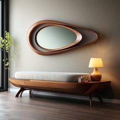 a bed with a mirror on the wall above it and a lamp next to it