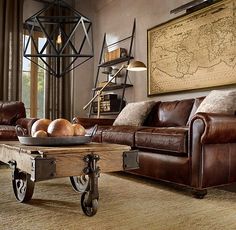 a living room filled with furniture and a map hanging on the wall above it's coffee table