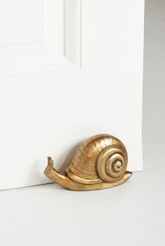 a golden snail is sitting on the door handle