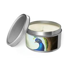 an open tin candle with a blue bird on it