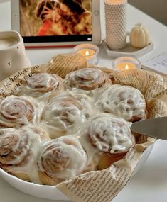 a plate with cinnamon rolls sitting on top of a table